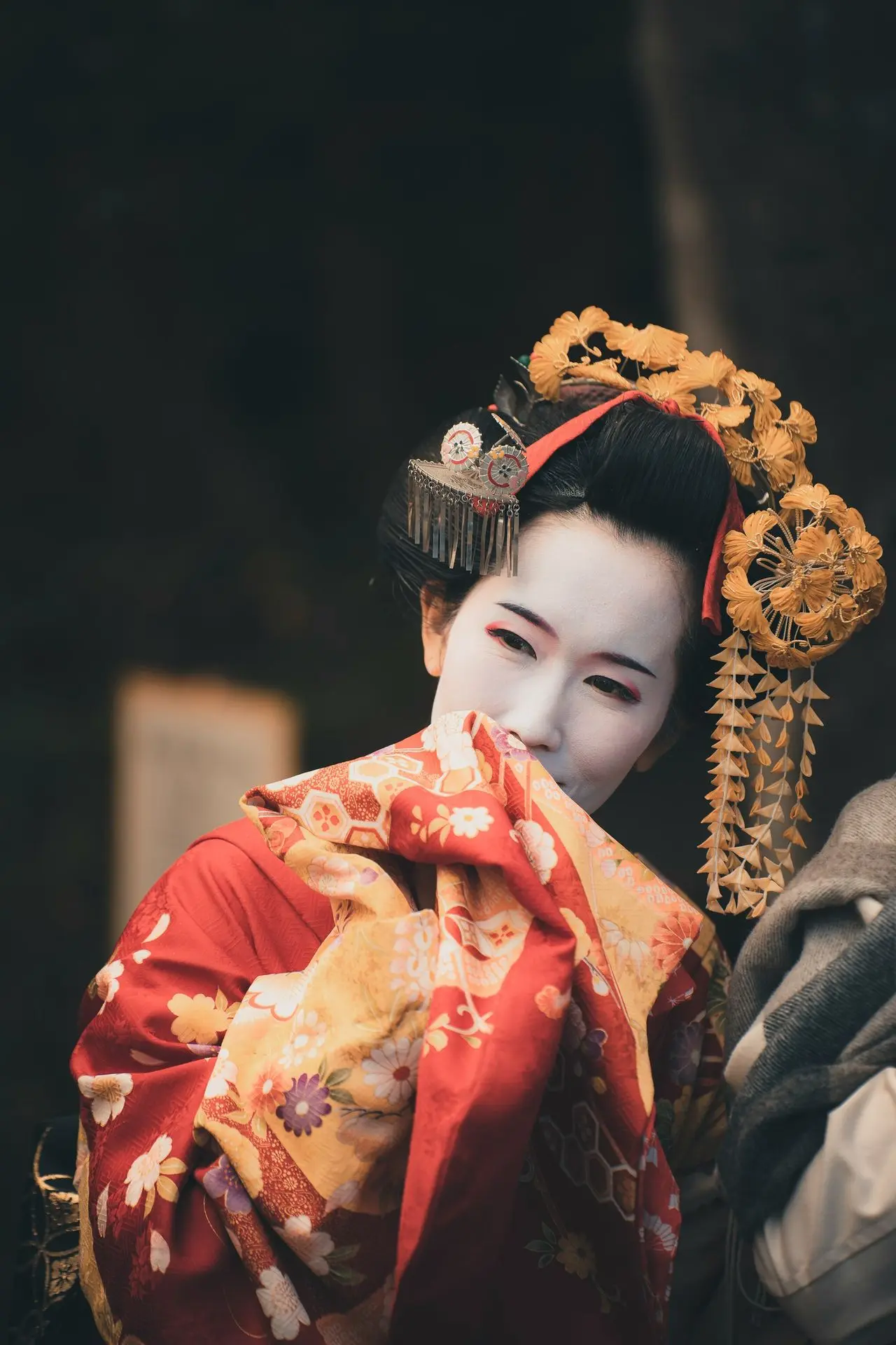 a woman in a geisha costume with a dragon on her head